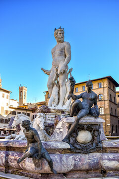 Florence, Italy - November 25, 2023 : large statue of Neptune with other mythical figures on octagonal fountain (16th century) in Piazza della Signoria