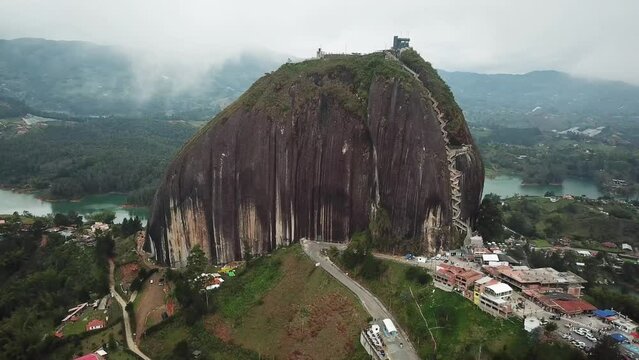 Aerial drone footage of El Penon de Guatape near Medellin in Antioquia, Colombia. Large and unique alone rock with stairs to the top, touristic place. Big stone in Colombia. High quality 4k footage.