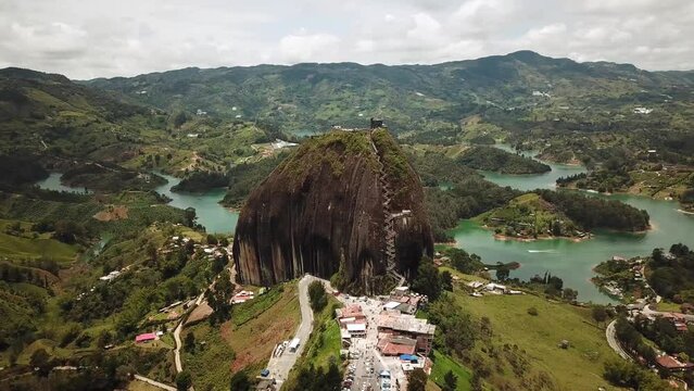 Aerial drone footage of El Penon de Guatape near Medellin in Antioquia, Colombia. Large and unique alone rock with stairs to the top, touristic place. Big stone in Colombia. High quality 4k footage.