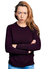 Young caucasian woman wearing casual clothes skeptic and nervous, disapproving expression on face with crossed arms. negative person.