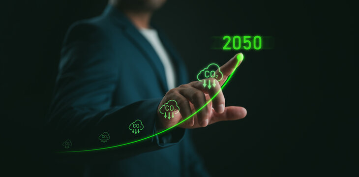 Businessman point to increasing arrow with carbon reduction for decrease CO2, carbon footprint and carbon credit to limit global warming from climate change, Bio Circular Green Economy concept.