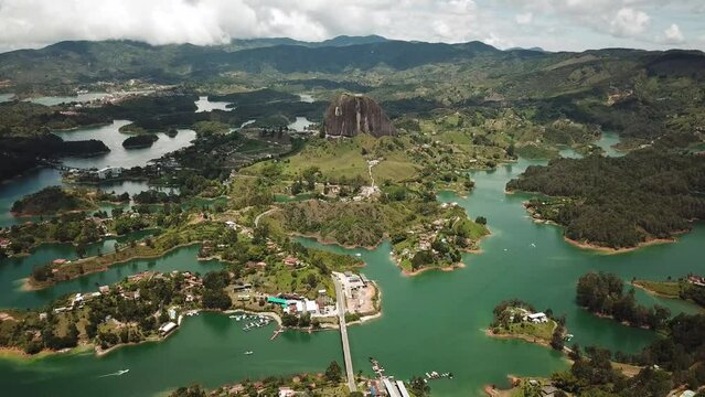 Aerial drone footage of El Penon de Guatape near Medellin in Antioquia, Colombia. Large and unique alone rock with stairs to the top, touristic place. Big stone in Colombia. High quality 4k footage.
