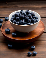 Closeup photo of blueberries in a ceramic Japanese bowl on a beautiful wooden table