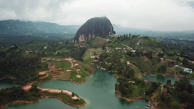 Aerial drone footage of El Penon de Guatape near Medellin in Antioquia, Colombia. Large and unique alone rock with stairs to the top, touristic place. Big stone in Colombia. High quality 4k footage.