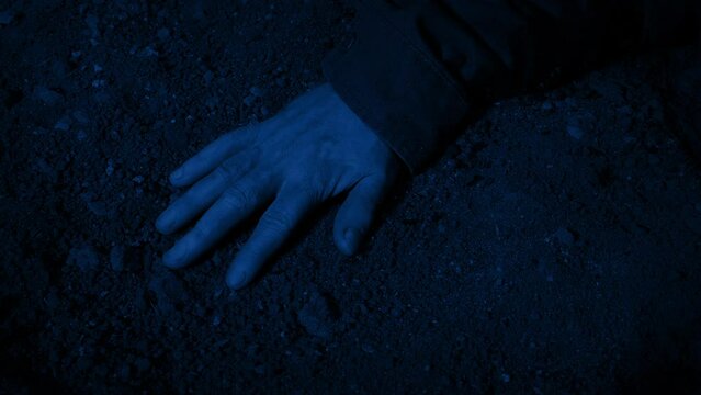 Man's Arm On The Ground At Night