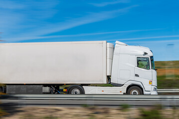 Truck with refrigerated semi-trailer with speed effect and the rest of the image blurred,...
