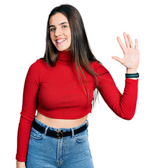 Young brunette teenager wearing red turtleneck sweater showing and pointing up with fingers number five while smiling confident and happy.