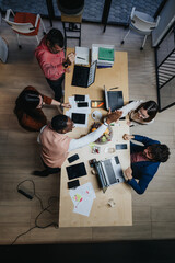 Above view photo of multicultural team collaborating in office, discussing project details,...