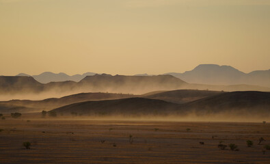 Sunset in the desert and mountains, sandstorm. Damaraland, Namibia  - obrazy, fototapety, plakaty