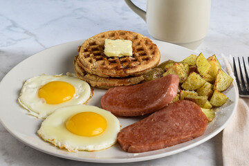 fried eggs with spam  served with waffles and home fries