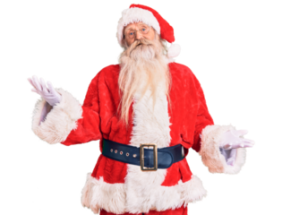 Old senior man with grey hair and long beard wearing traditional santa claus costume smiling cheerful with open arms as friendly welcome, positive and confident greetings