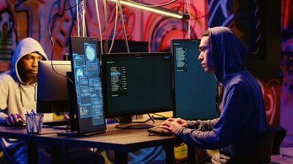 Asian hacker arriving in graffiti painted underground bunker, starting work on stealing valuable data using phishing technique. Cybercriminal tricking users into revealing sensitive information - obrazy, fototapety, plakaty