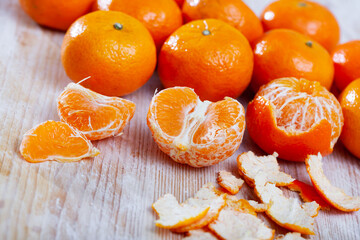 Many tasty clementines on wooden surface. High quality photo