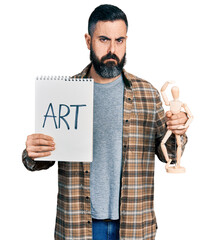 Hispanic man with beard holding art notebook and manikin depressed and worry for distress, crying...