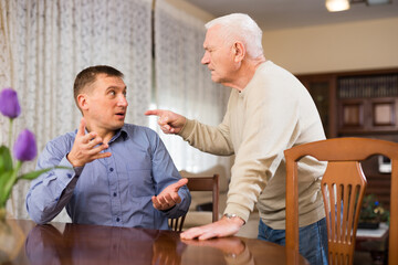 Home quarrel between father and adult son. High quality photo