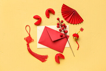 Composition with envelopes, tasty fortune cookies and Chinese symbols on color background. New Year celebration