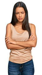 Obraz premium Beautiful hispanic woman wearing casual clothes skeptic and nervous, disapproving expression on face with crossed arms. negative person.