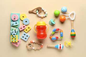 Wooden educational toys blocks with baby bottle on orange background - obrazy, fototapety, plakaty