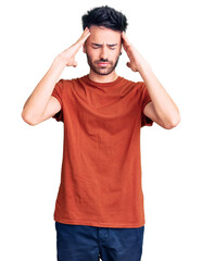 Young hispanic man wearing casual clothes suffering from headache desperate and stressed because pain and migraine. hands on head.