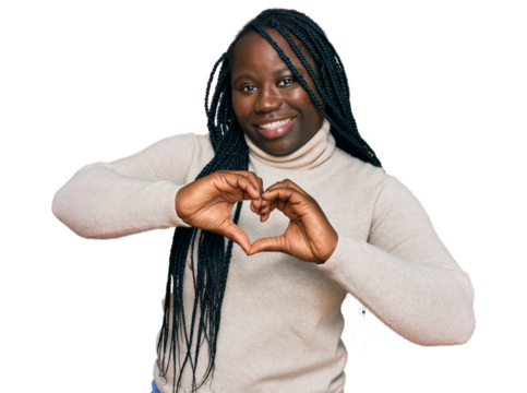 Young black woman with braids wearing casual winter sweater smiling in love showing heart symbol and shape with hands. romantic concept.