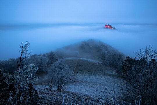 Hohenzollern Castle with Christmas lights in the fog from the Zeller Horn, Hechingen, Swabian Alb, Baden-Wuerttemberg, Germany, Europe