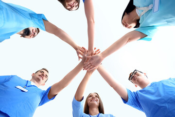 Group of medical students putting hands together, bottom view