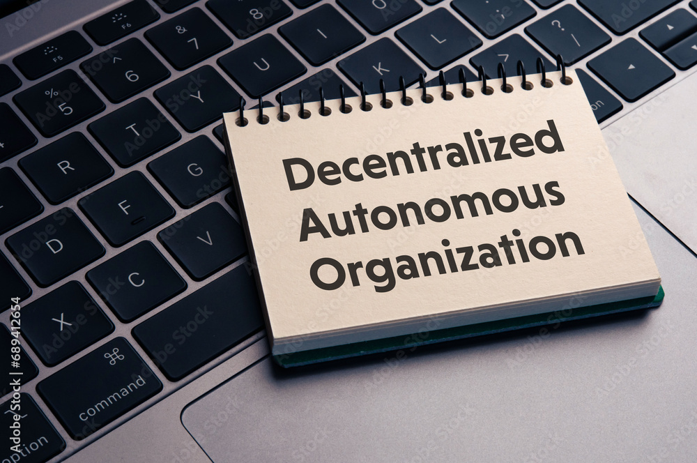 Poster there is notebook with the word decentralized autonomous organization. it is as an eye-catching imag