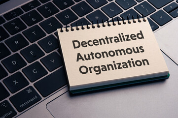 There is notebook with the word Decentralized Autonomous Organization. It is as an eye-catching image.