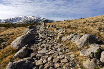 Main path that goes up to the big lake of Gredos Natural park in a sunny winter day. Ávila, Castilla y León, Spain.