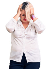 Young blonde plus size woman wearing casual shirt suffering from headache desperate and stressed because pain and migraine. hands on head.