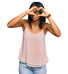 Young african american woman wearing casual clothes and glasses doing heart shape with hand and fingers smiling looking through sign