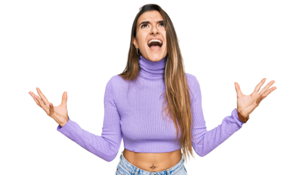 Young hispanic woman wearing casual clothes crazy and mad shouting and yelling with aggressive expression and arms raised. frustration concept.