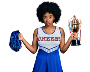 Young african american woman wearing cheerleader uniform holding pompom and trophy skeptic and nervous, frowning upset because of problem. negative person.