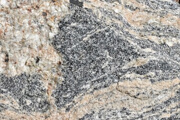 black and orange brown rock texture with cracks. Close-up. Rough mountain surface. Stone granite background for design. Nature.