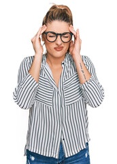 Obraz na płótnie Canvas Young caucasian woman wearing business shirt and glasses with hand on head for pain in head because stress. suffering migraine.
