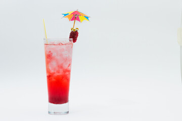 Cocktail drink with blackberries, straw and umbrella isolated on white background.