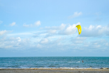sea water with blue sky. people are playing parachute.