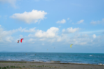 sea water with blue sky. people are playing parachute.