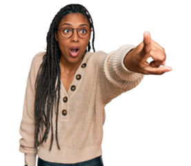 African american woman wearing casual clothes pointing with finger surprised ahead, open mouth amazed expression, something on the front