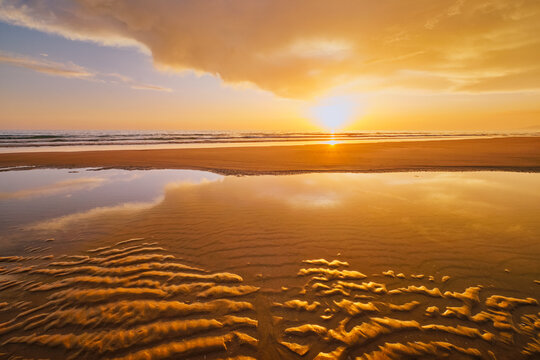 Atlantic ocean sunset with surging waves at Fonte da Telha beach, Costa da Caparica, Portugal