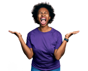African american woman with afro hair wearing casual purple t shirt celebrating mad and crazy for success with arms raised and closed eyes screaming excited. winner concept
