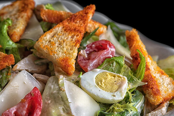 Caesar salad with, herbs and tomatoes on a plate