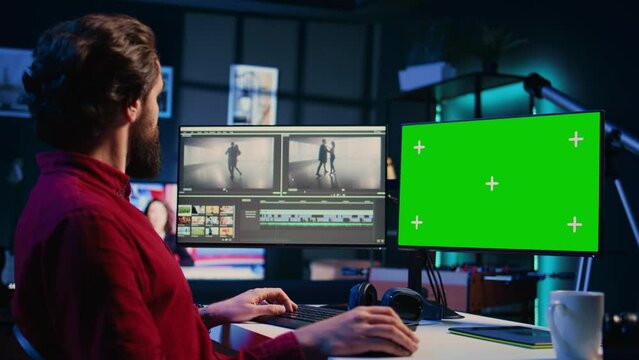 Videographer uses editing software on chroma key computer to assemble footage into cohesive final result. Expert color correcting clips on isolated screen PC to ensure project meets desired aesthetic