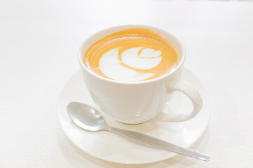 hot latte art coffee in white ceramic cup
