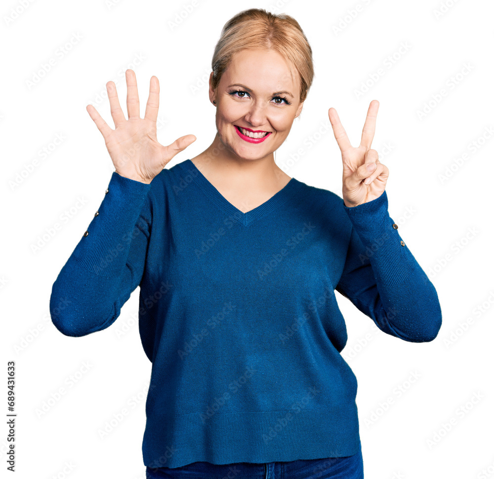 Wall mural Young blonde woman wearing casual clothes showing and pointing up with fingers number seven while smiling confident and happy.