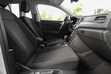 Stylish car interior with steering wheel and comfortable seats inside