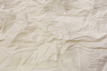 Texture of crumpled beige paper as background, closeup view