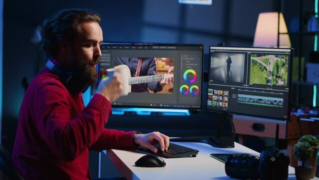 Video editor correcting faulty footage, grading and coloring, enjoying cup of coffee in creative studio. Videographer adding special effects to clips, drinking hot beverage in media company office