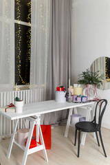 New Year's table with colorful gifts and flower arrangement. Christmas