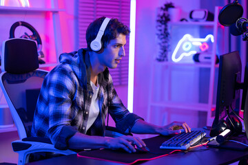 Fototapeta na wymiar Caucasian young Esport male gamer play online video game on computer. 